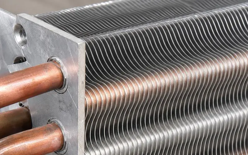 Wavy heat exchanger fins designed to guide airflow through a coil